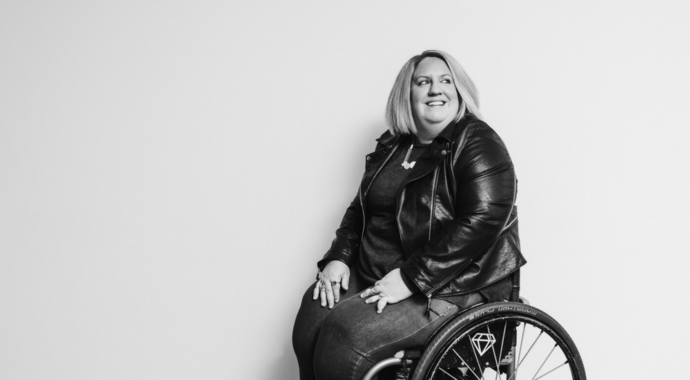 Woman in wheelchair looking off camera and smiling