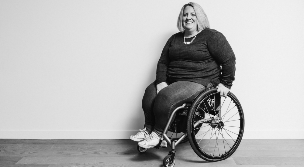 Woman in a wheelchair smiling at the camera