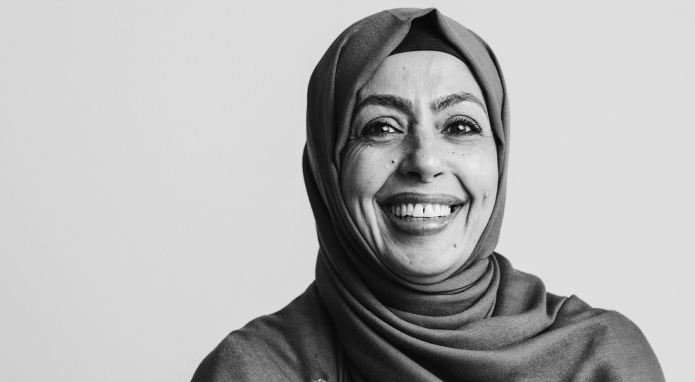 Woman wearing a hijab looking at the camera and smiling